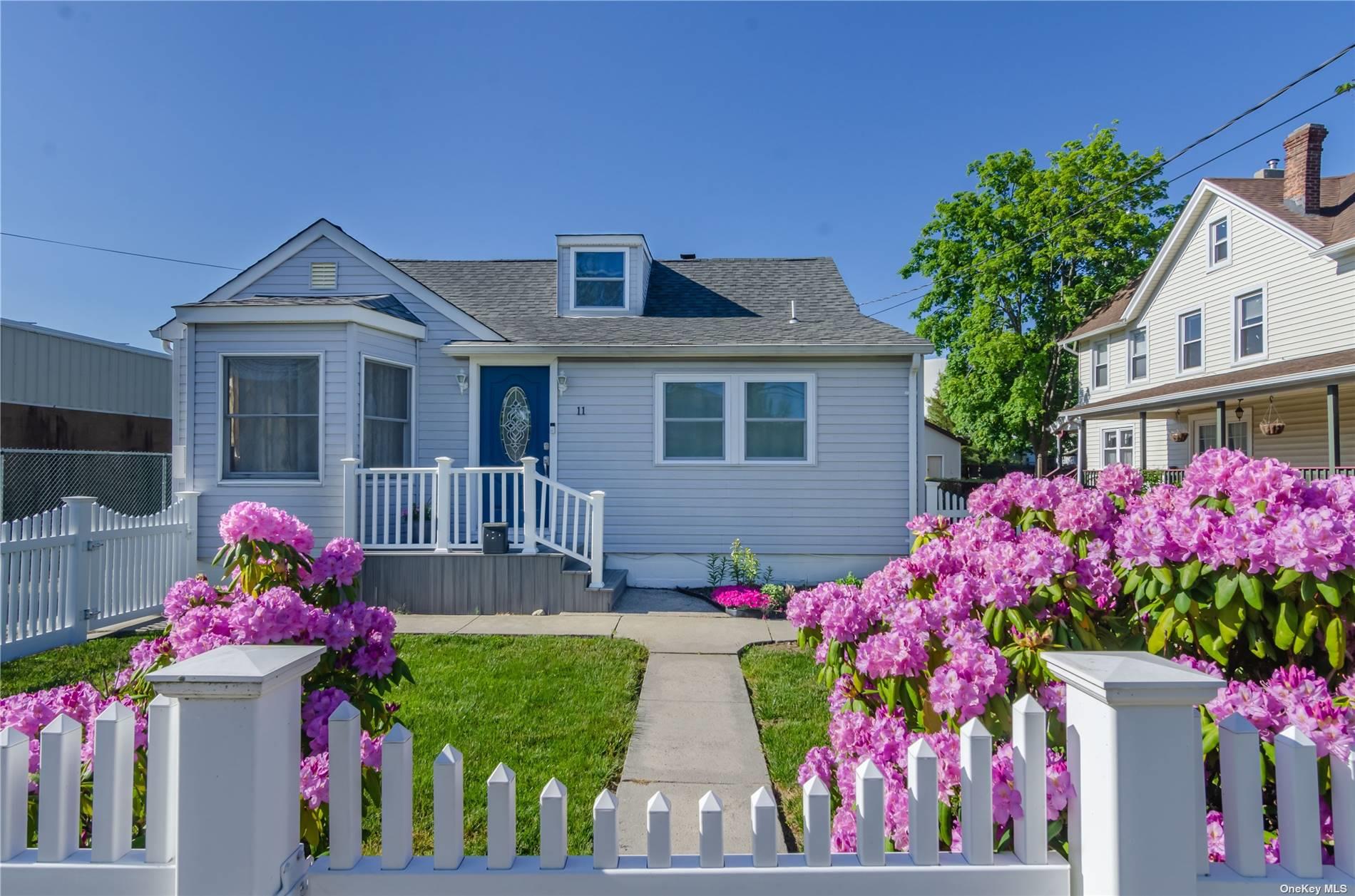 11 Edwards Street Patchogue, NY 11772 - Photo 1 of 1 a front view of house and yard and entertaining space