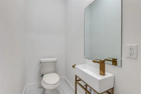 a white toilet sitting next to a bathroom sink