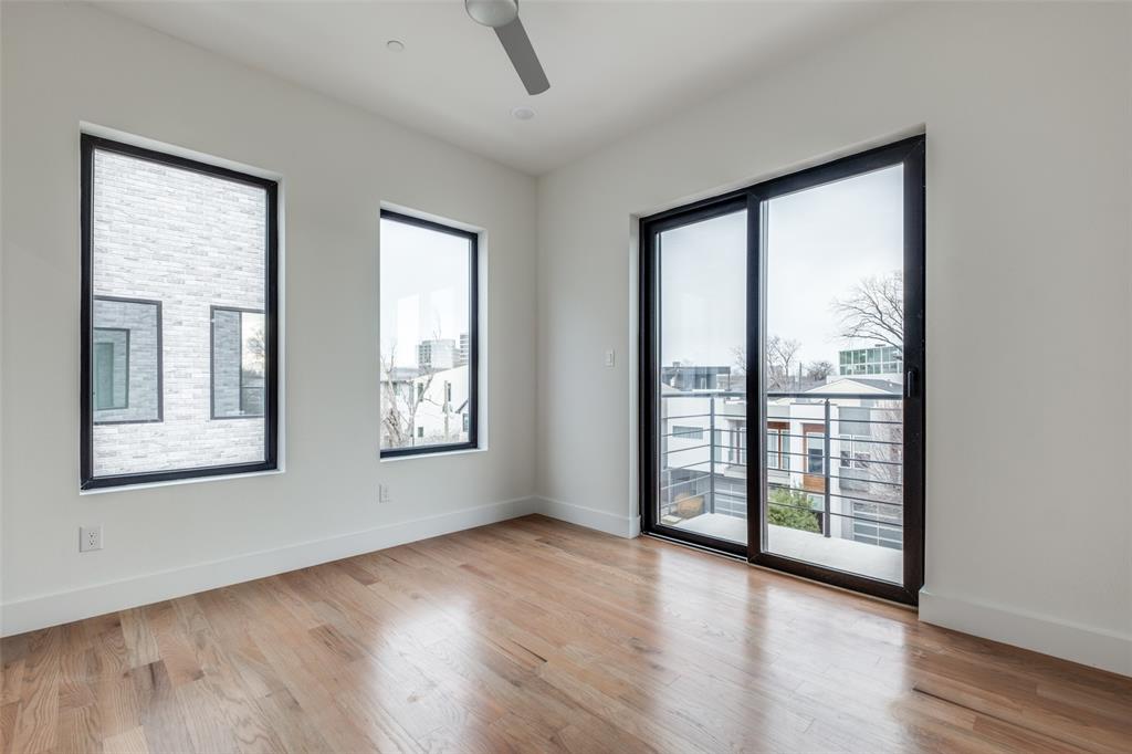 2607 Calvin Street, Unit 3 Dallas, TX 75204 - Photo 18 of 26 a view of an empty room with wooden floor and a window