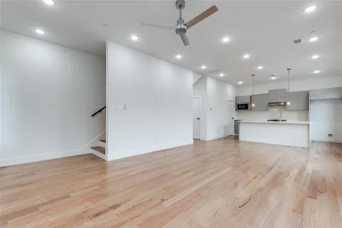 a view of a kitchen with a sink and a refrigerator