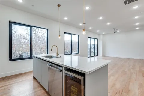a kitchen with counter top a sink and dishwasher
