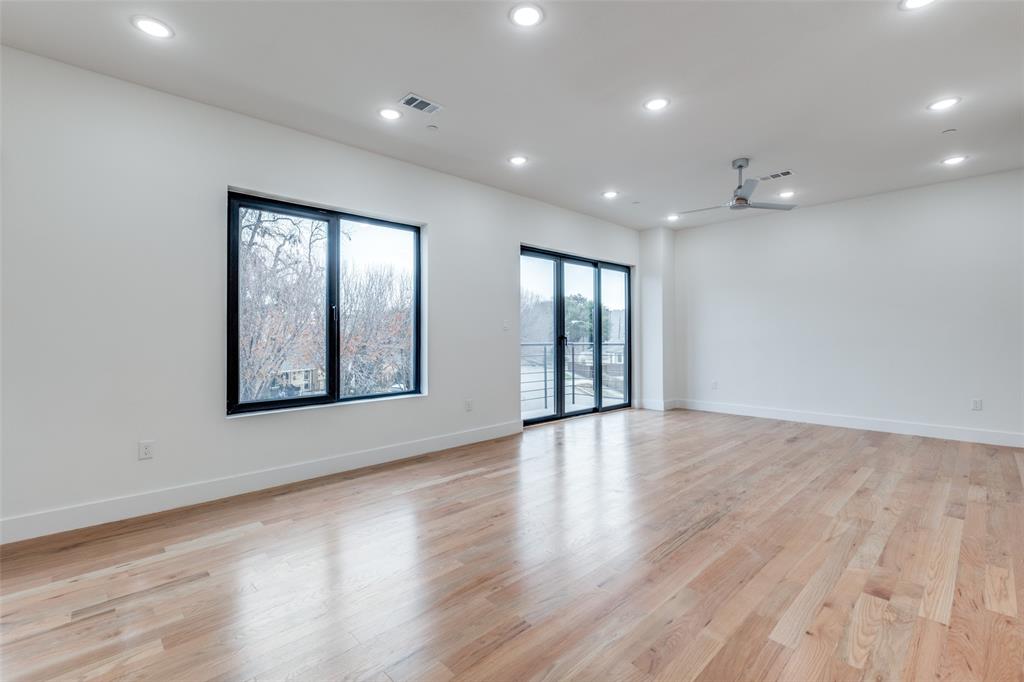 2607 Calvin Street, Unit 3 Dallas, TX 75204 - Photo 10 of 26 an empty room with wooden floor and windows