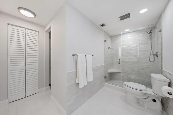 a bathroom with a toilet a sink and shower