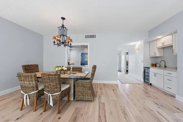 a view of a dining room with furniture wooden floor and chandelier