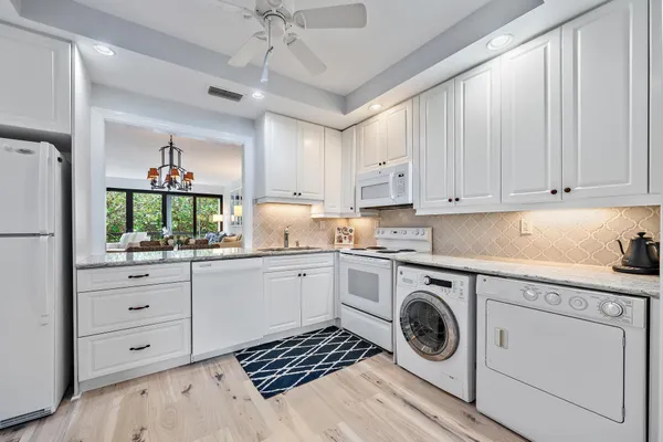 a kitchen with sink cabinets and stove