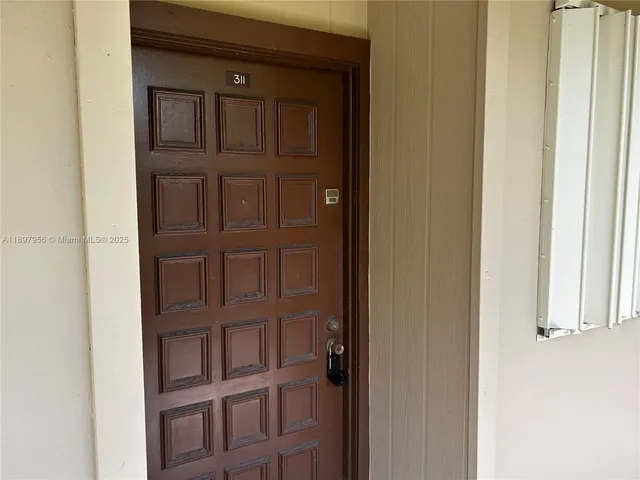 a bathroom with a granite countertop toilet and a sink