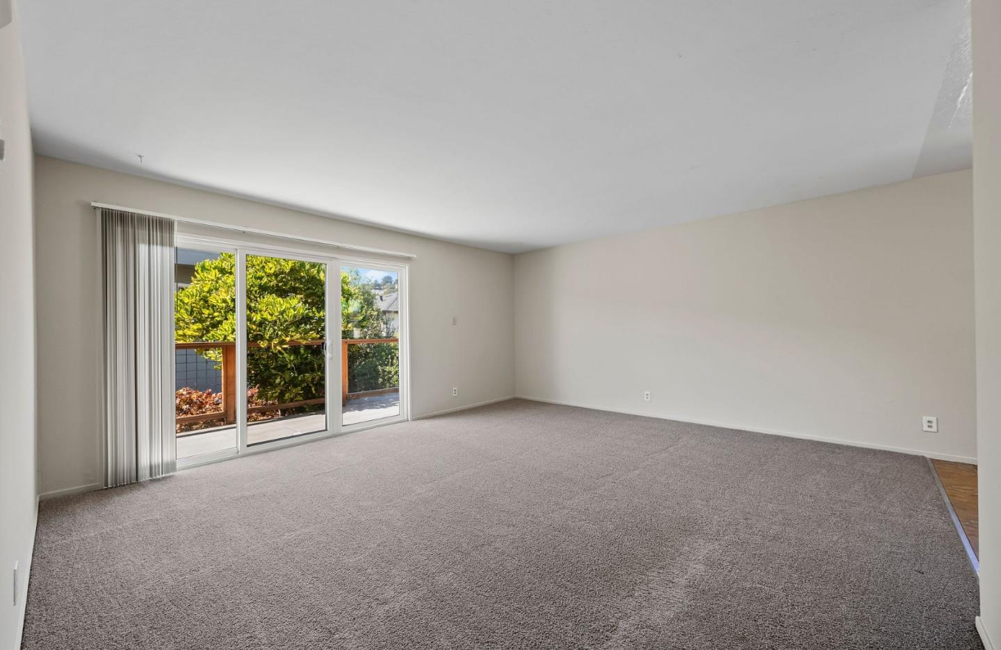620 Masonic Way Belmont, CA 94002 - Photo 4 of 8 an empty room with large windows and garden view