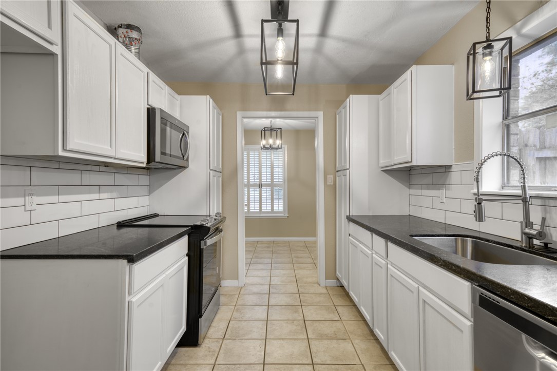 1212 Ridgefield Circle South College Station, TX 77840 - Photo 12 of 23 a kitchen that has a sink and cabinets