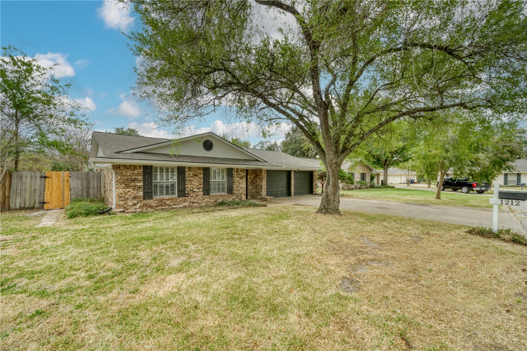 1212 Ridgefield Circle South College Station, TX 77840 - Photo 2 of 23 a front view of a house with a yard