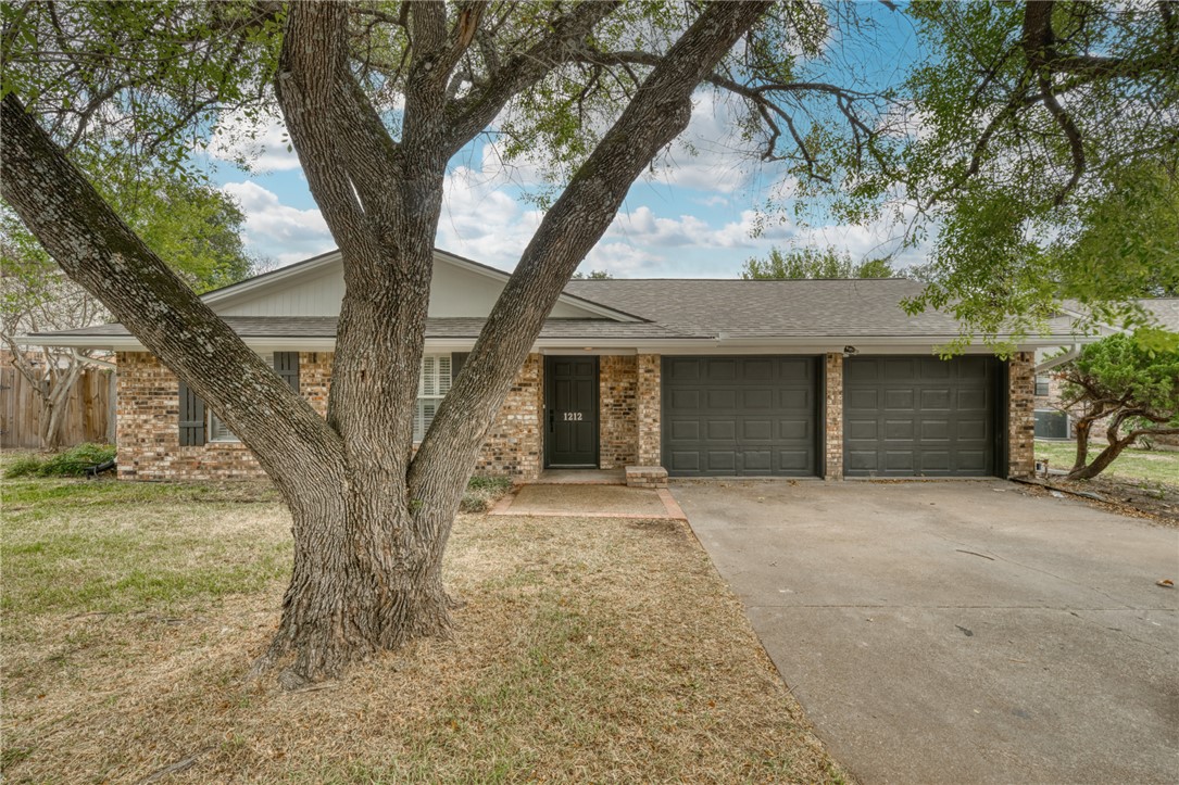 1212 Ridgefield Circle South College Station, TX 77840 - Photo 23 of 23 a front view of a house with garden