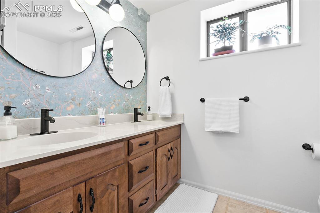 1225 Montezuma Road Colorado Springs, CO 80920 - Photo 16 of 44 Bathroom with double vanity, tile patterned flooring, and wallpapered walls