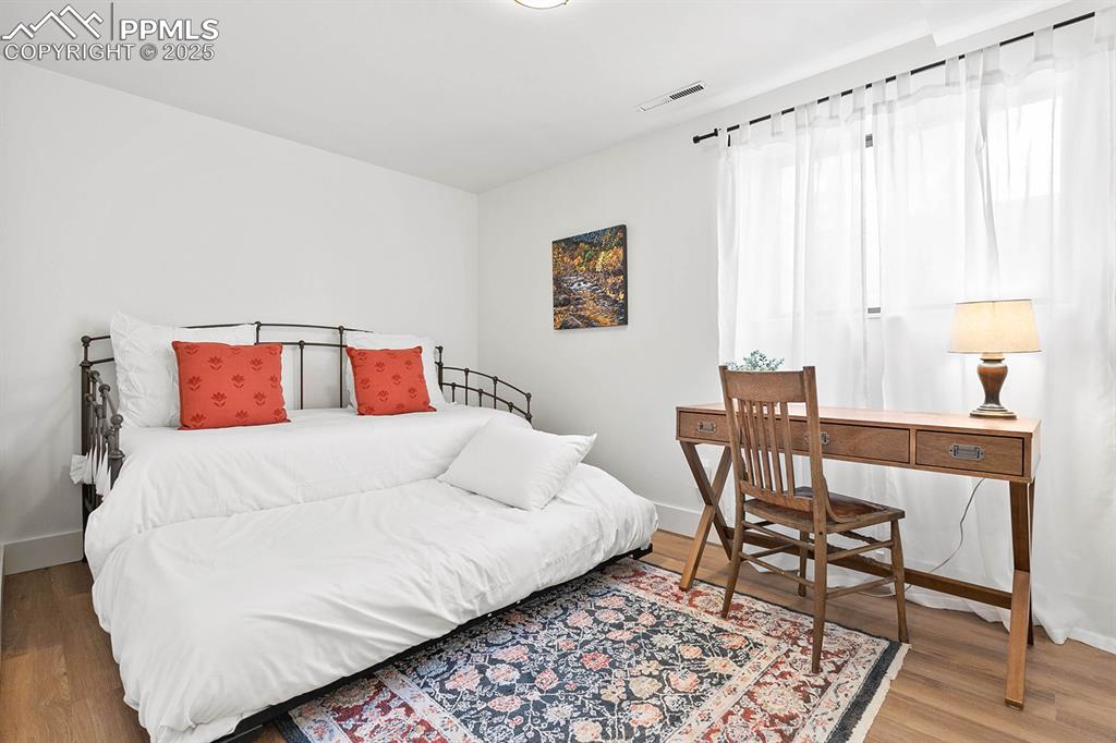1225 Montezuma Road Colorado Springs, CO 80920 - Photo 18 of 44 Bedroom with baseboards and wood finished floors