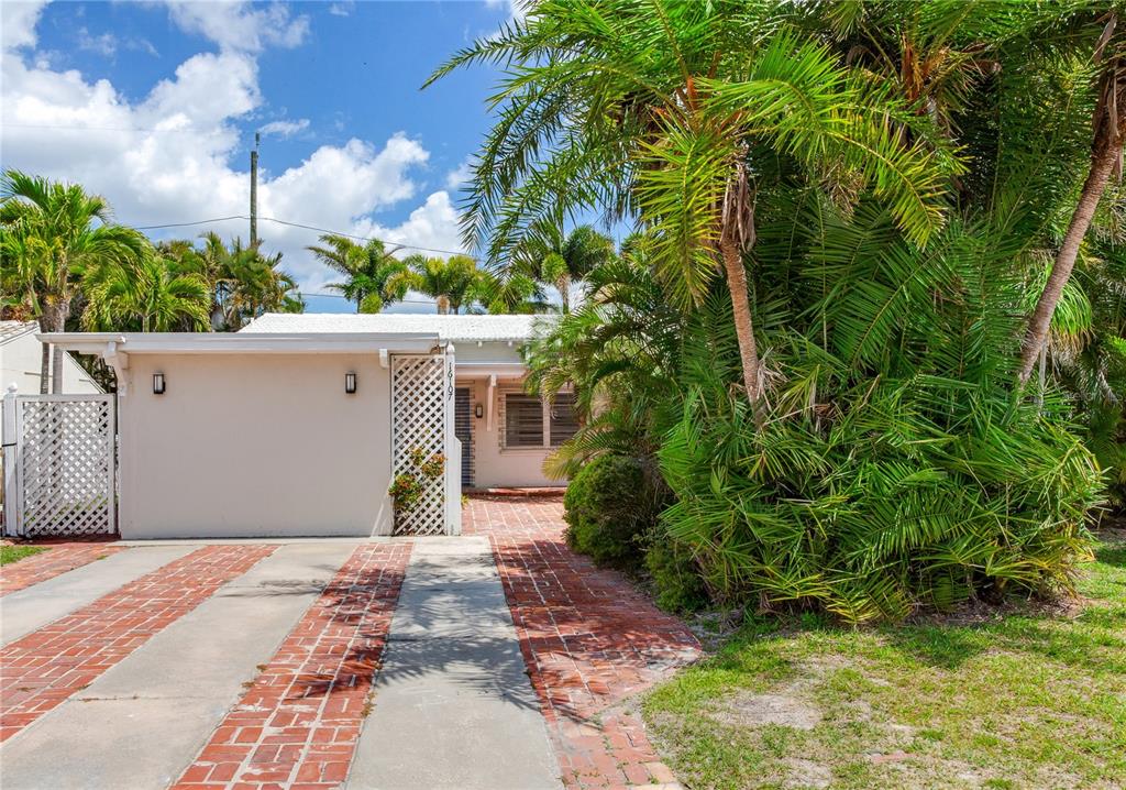 16107 Gulf Boulevard Redington Beach, FL 33708 - Photo 15 of 50 a front view of a house with garden