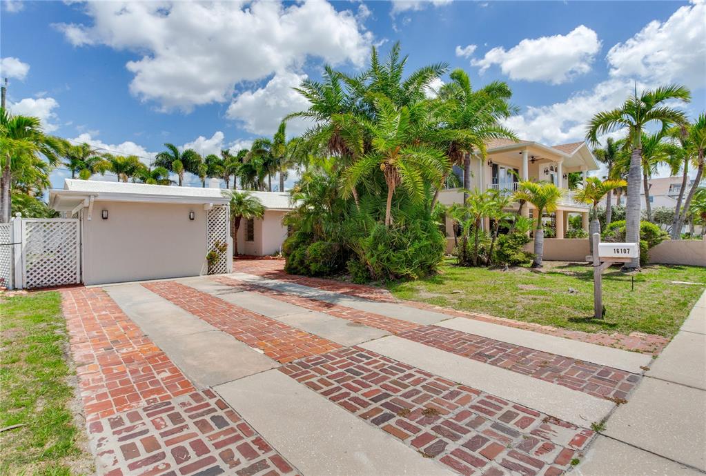 16107 Gulf Boulevard Redington Beach, FL 33708 - Photo 41 of 50 a front view of a house with garden
