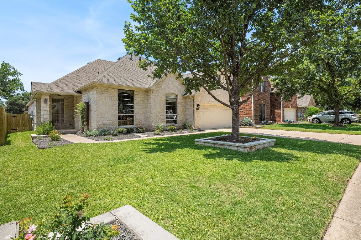14936 Thatcher Drive Austin, TX 78717 - Photo 1 of 1 a front view of a house with yard and green space