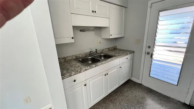 a kitchen with a refrigerator and stove