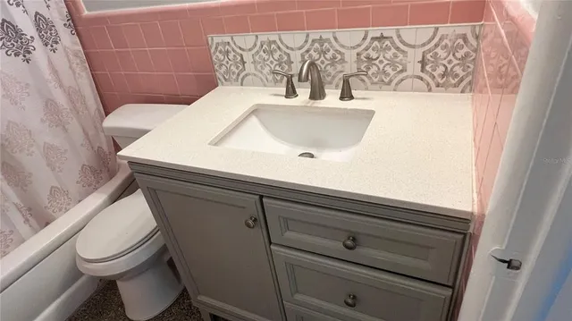 a bathroom with a sink and toilet