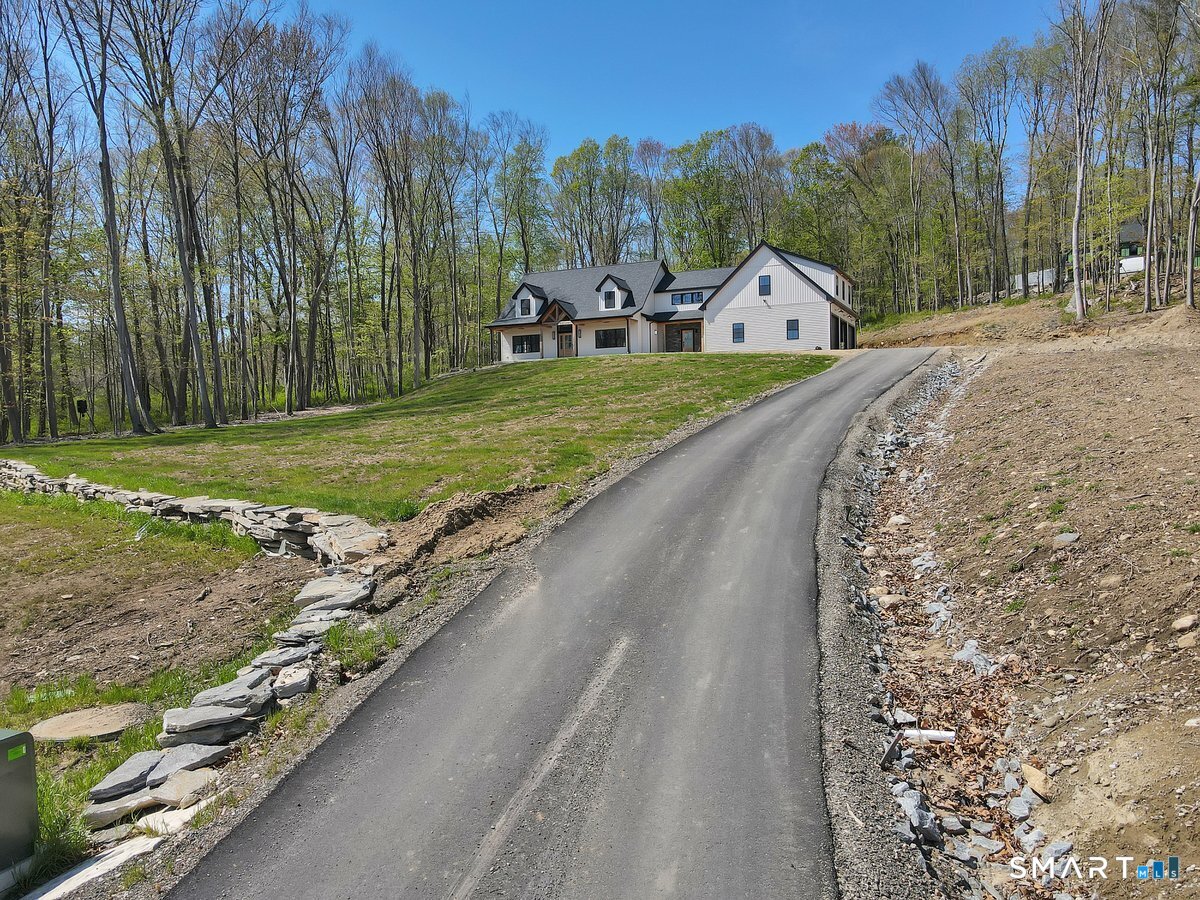 106 South Street Extension Coventry, CT 06238 - Photo 26 of 33 a view of a white house with a big yard and large trees