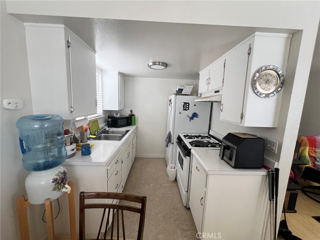 375 Surf Street Morro Bay, CA 93442 - Photo 12 of 25 a kitchen with stainless steel appliances granite countertop a stove and a refrigerator