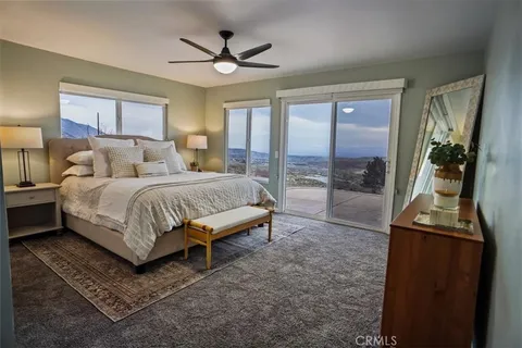 a bedroom with a large bed and a chandelier