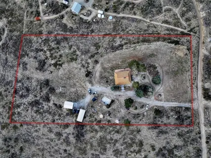 a aerial view of a house with a yard