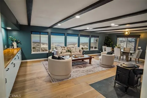 a living room with furniture large window and flat screen tv