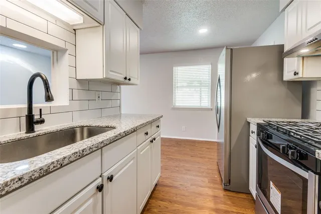 a kitchen with cabinets a sink and appliances