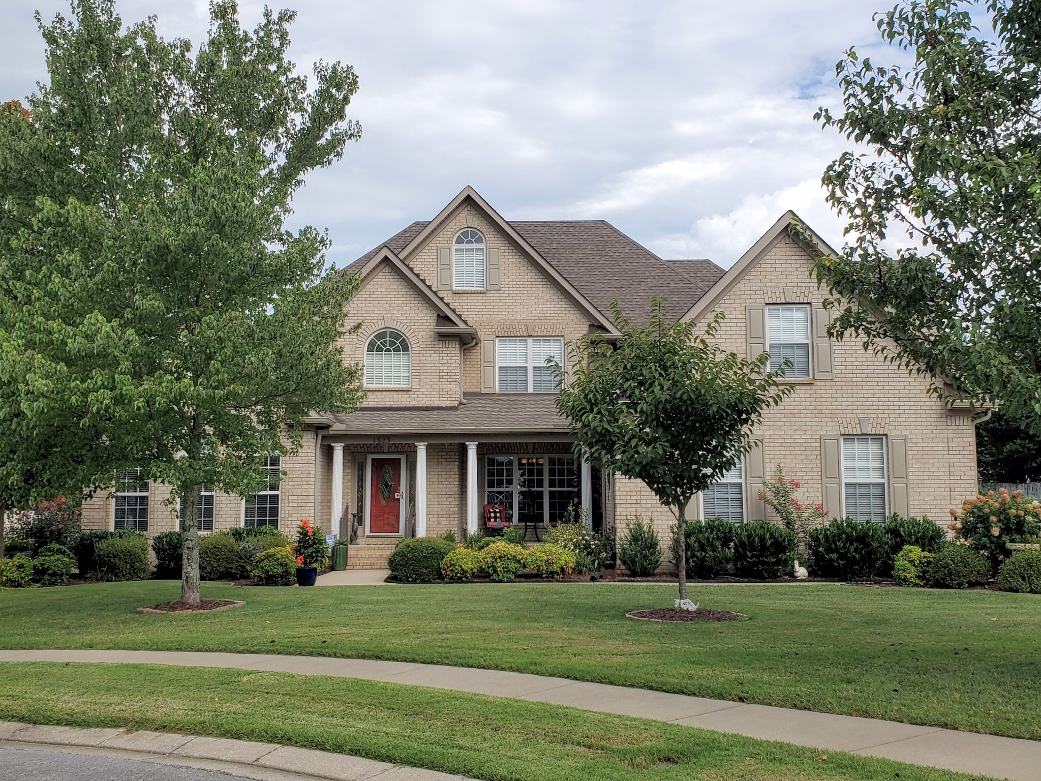 a front view of a house with a yard