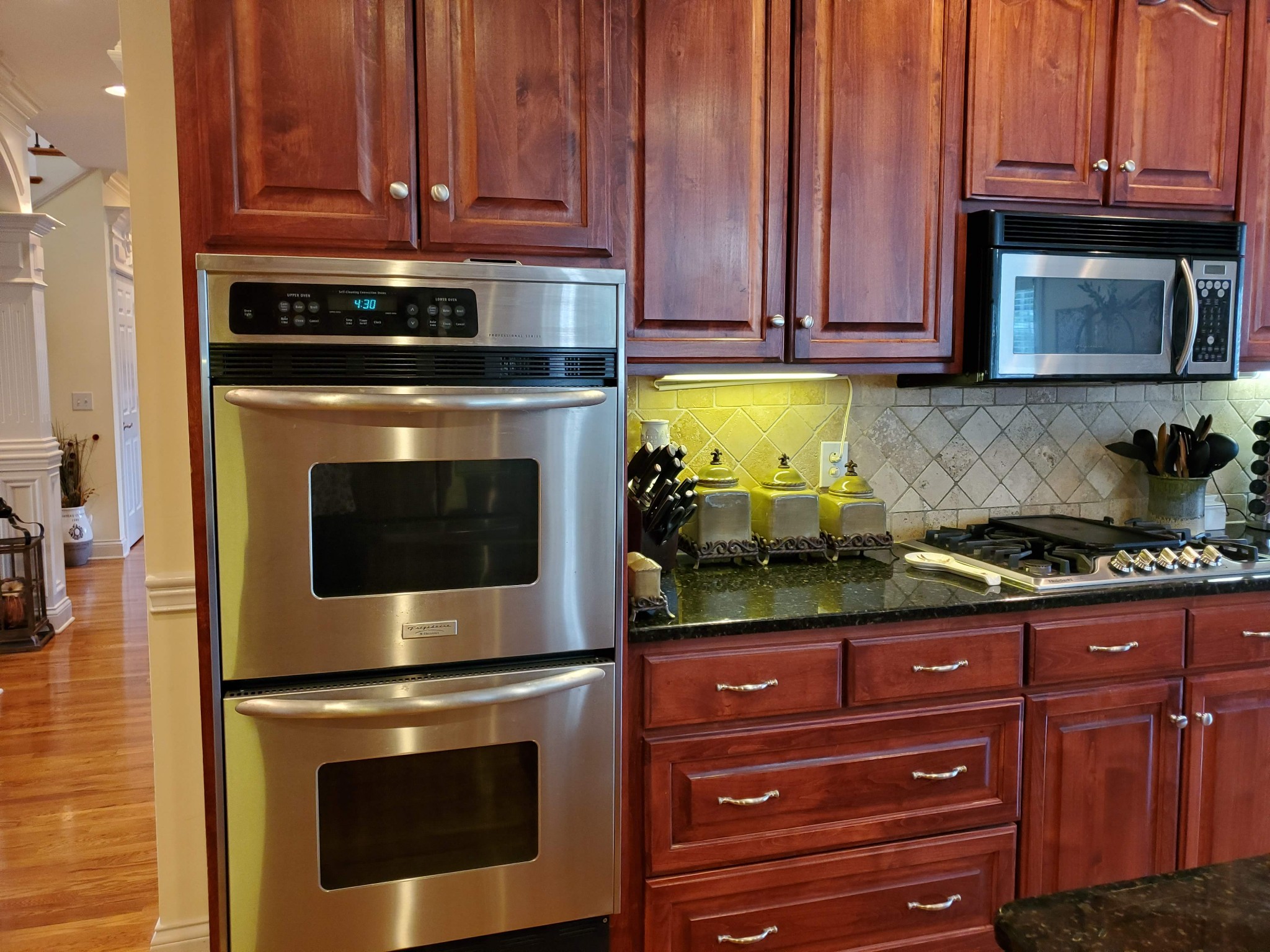 1523 Winterberry Drive Murfreesboro, TN 37130 - Photo 19 of 42 a kitchen with granite countertop wooden cabinets and stainless steel appliances