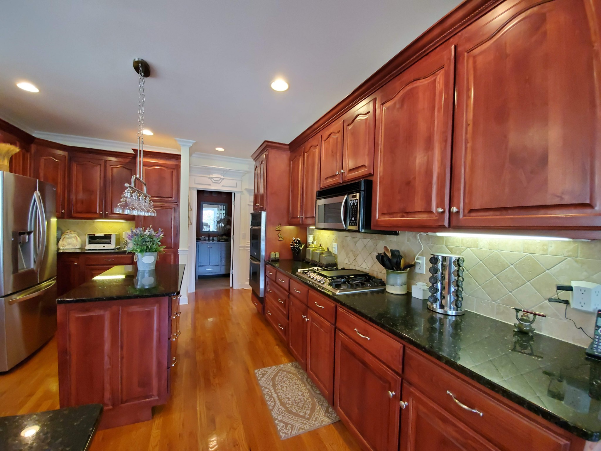 1523 Winterberry Drive Murfreesboro, TN 37130 - Photo 23 of 42 a kitchen with stainless steel appliances granite countertop wooden cabinets a stove top oven a sink and dishwasher