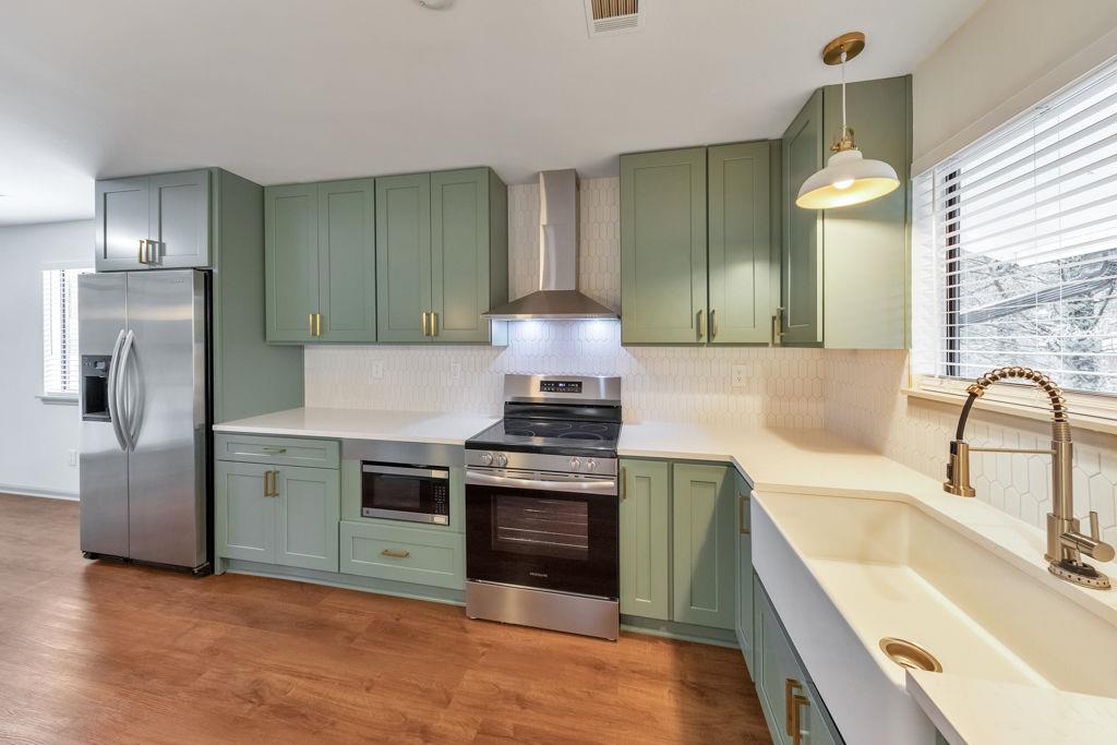 1535 Rucker Road Alpharetta, GA 30009 - Photo 16 of 42 a kitchen with a stove and a sink