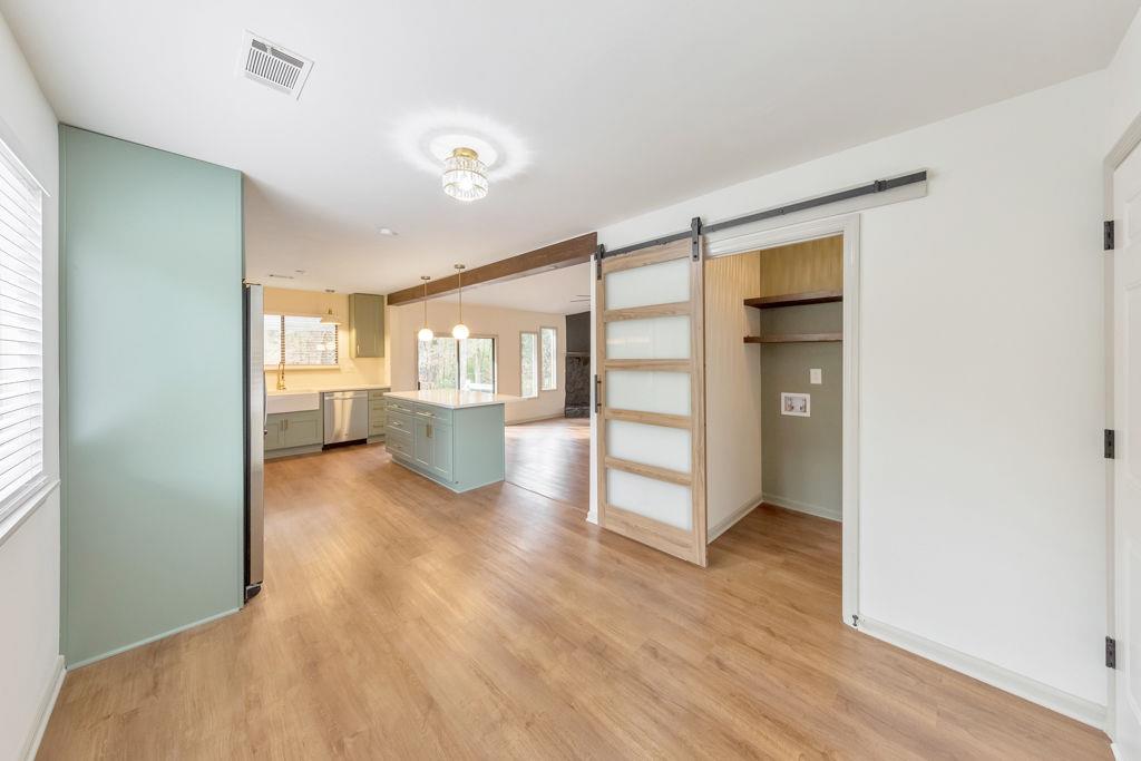 1535 Rucker Road Alpharetta, GA 30009 - Photo 17 of 42 a view of a big room with wooden floor kitchen view and windows