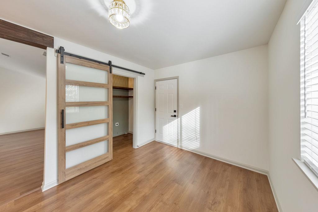 1535 Rucker Road Alpharetta, GA 30009 - Photo 18 of 42 a view of an empty room with a window and wooden floor