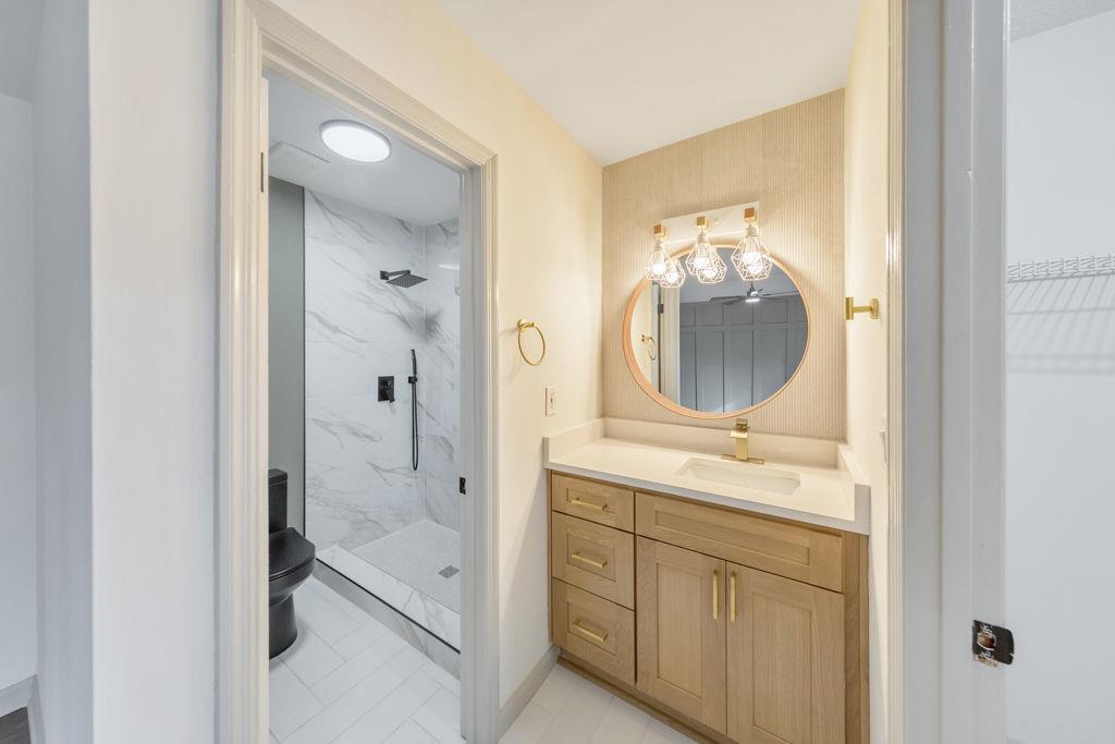 1535 Rucker Road Alpharetta, GA 30009 - Photo 23 of 42 a en suite bathroom with a granite countertop sink mirror and shower