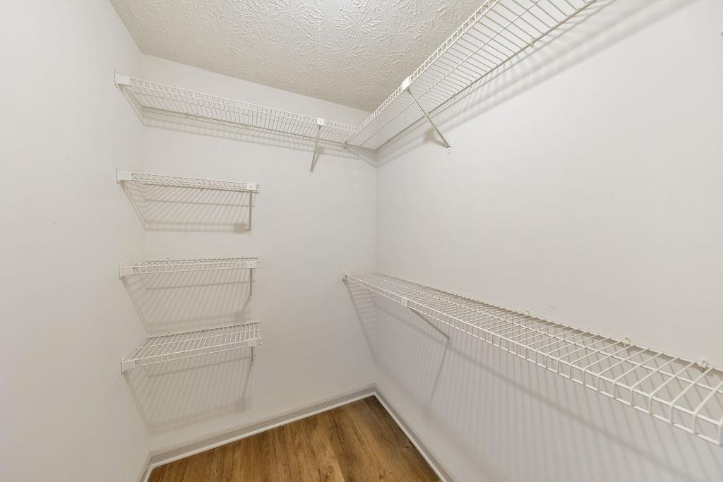 1535 Rucker Road Alpharetta, GA 30009 - Photo 26 of 42 a view of walk in closet with empty racks