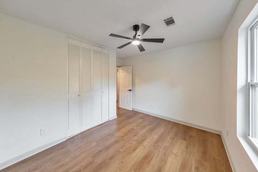 1535 Rucker Road Alpharetta, GA 30009 - Photo 28 of 42 an empty room with wooden floor a ceiling fan and windows