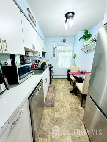 a bedroom with two beds and painting on the wall