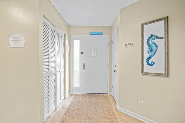 a view of a hallway with front door