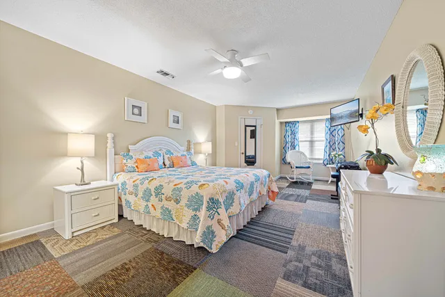 a bedroom with bed and a chandelier