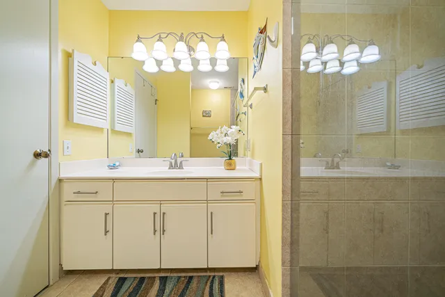 a bathroom with a double vanity sink mirror and
