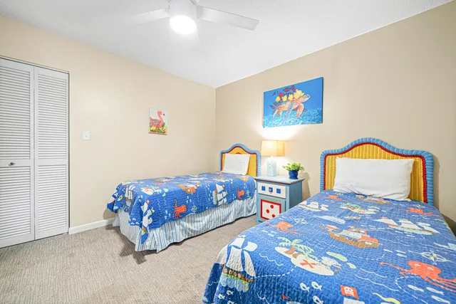 a bedroom with two beds and a table