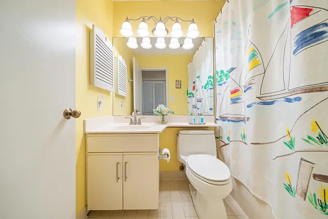 a bathroom with a sink a mirror and a toilet
