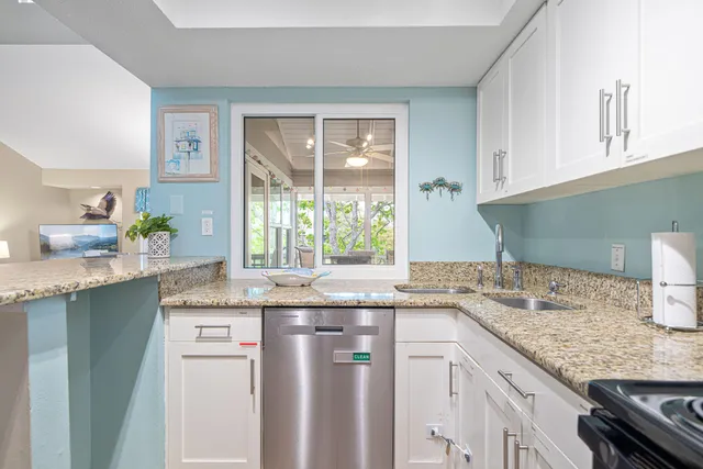 a kitchen with granite countertop a sink and a window