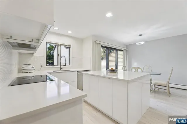 a kitchen with granite countertop a sink and cabinets
