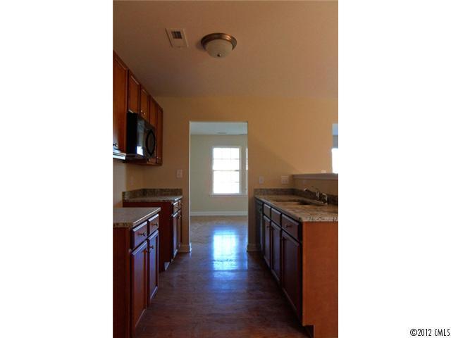 12429 Stumptown Road, Unit 4 Huntersville, NC 28078 - Photo 4 of 16 a kitchen with granite countertop a stove top oven