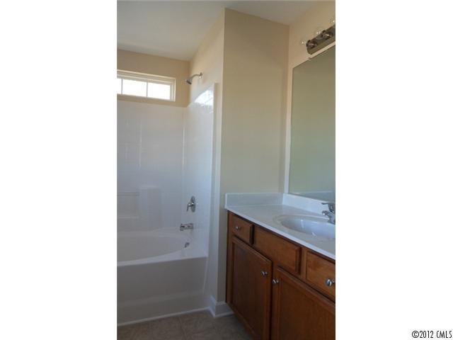 12429 Stumptown Road, Unit 4 Huntersville, NC 28078 - Photo 8 of 16 a bathroom with a sink a toilet and shower