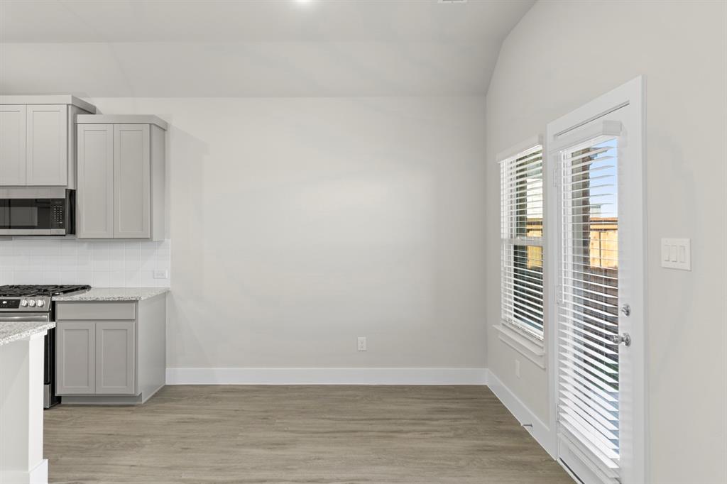 2372 Bell Way Forney, TX 75126 - Photo 20 of 39 a view of a kitchen with wooden floor and a window