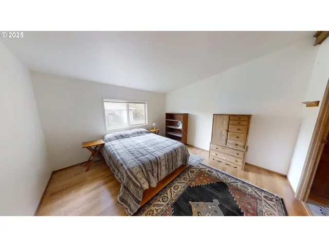 a room with a bed and a television