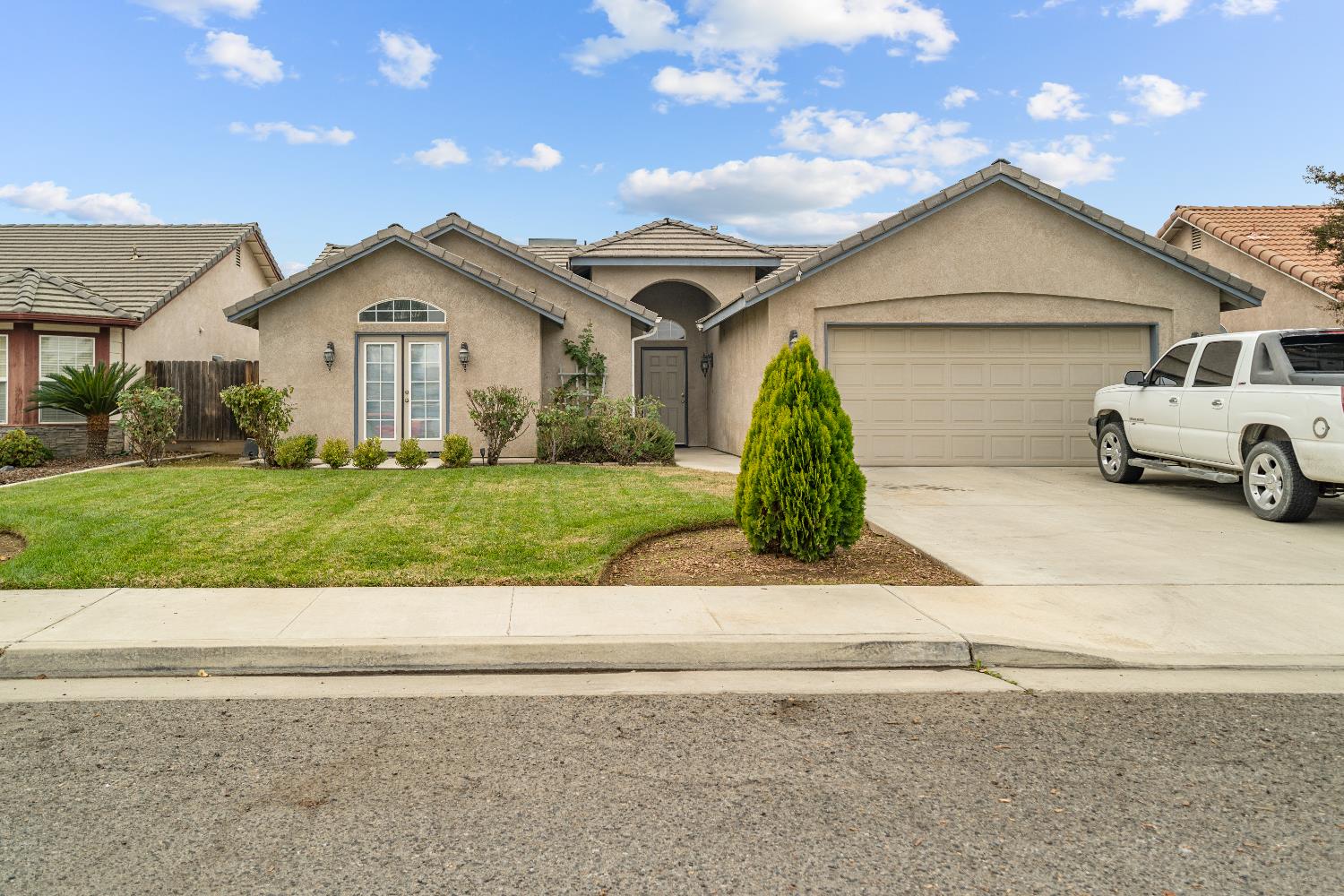 a front view of a house with a yard and garage