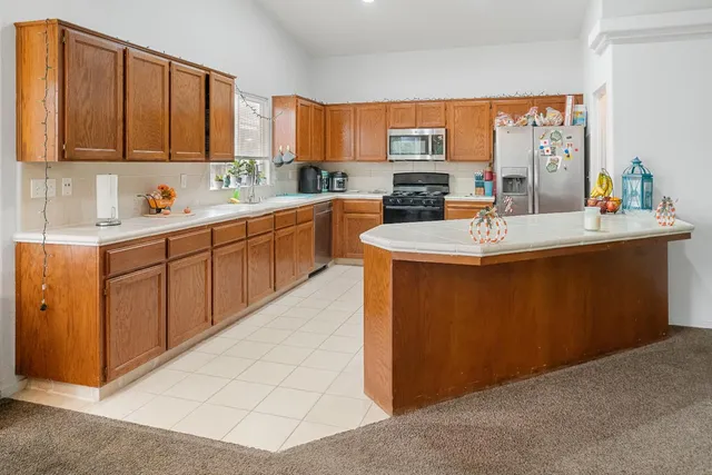 a kitchen with stainless steel appliances a sink and a refrigerator
